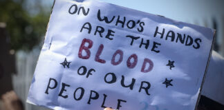 MITCHELL'S PLAIN, SOUTH AFRICA - JANUARY 25: Community members during a protest outside Mitchells Plain Police Station on January 25, 2024 in Mitchell's Plain, South Africa. It is alleged that 15 guns and 8 imitation guns were stolen or went missing from the SAPS in November 2023. (Photo by Gallo Images/Brenton Geach)