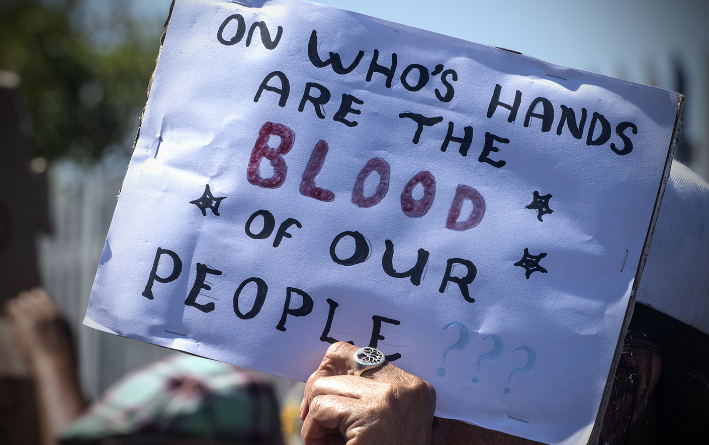 MITCHELL'S PLAIN, SOUTH AFRICA - JANUARY 25: Community members during a protest outside Mitchells Plain Police Station on January 25, 2024 in Mitchell's Plain, South Africa. It is alleged that 15 guns and 8 imitation guns were stolen or went missing from the SAPS in November 2023. (Photo by Gallo Images/Brenton Geach)