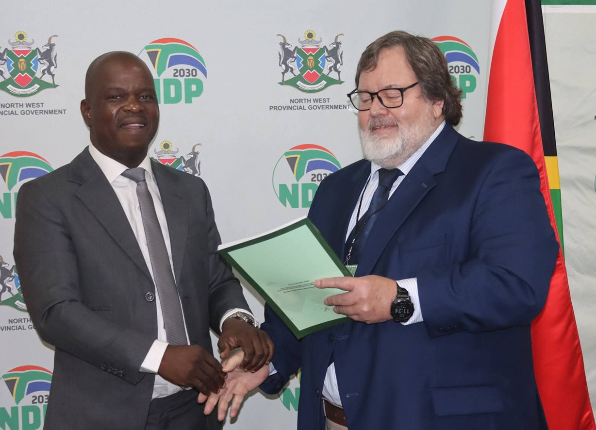 Prof Theo Venter hands over the Provincial Growth and Development Strategy (PGDS) document to North West Premier Lazarus Mokgosi at the official launch at Mmabatho Palms Hotel.