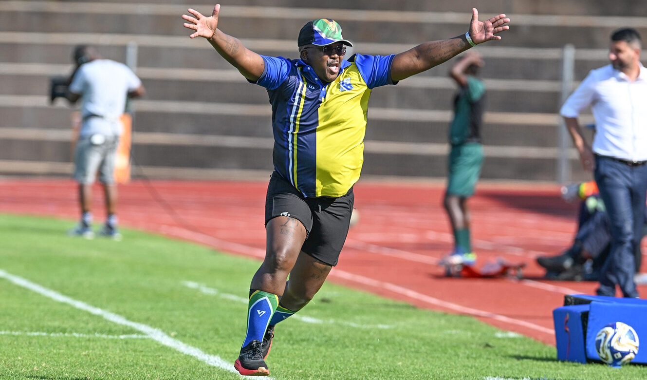 Milford FC head coach Xanti Pupuma celebrates on the sidelines during a soccer match