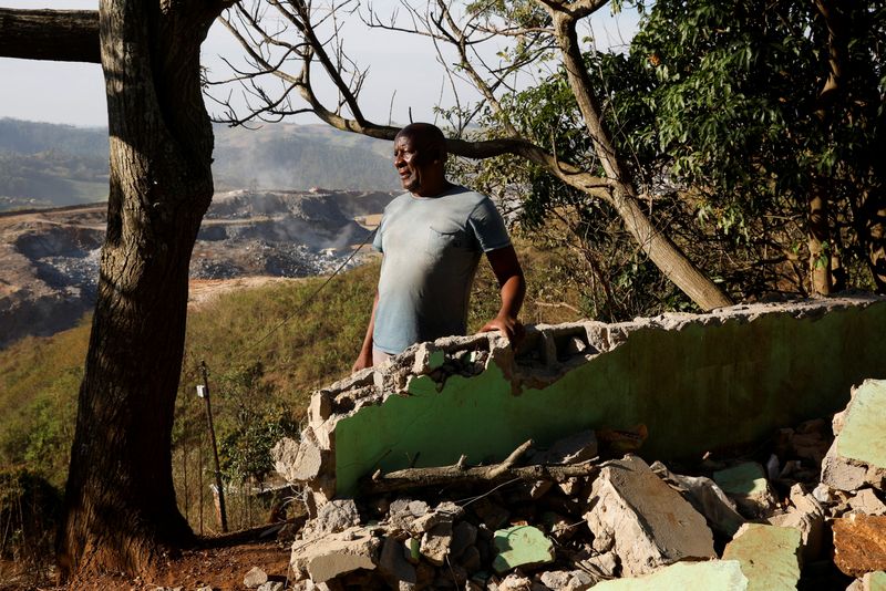 Albert Mthembu next to a demolished house in Magog, South Africa.