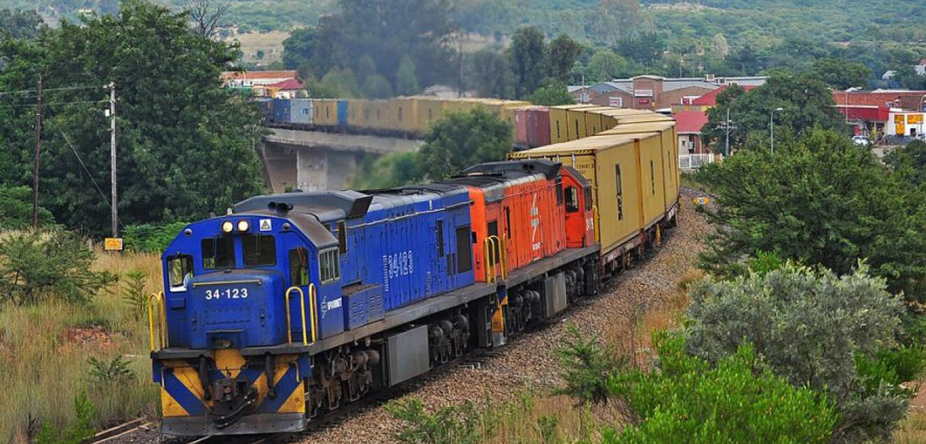 Train on a railway line representing South African freight rail infrastructure and logistics network.
