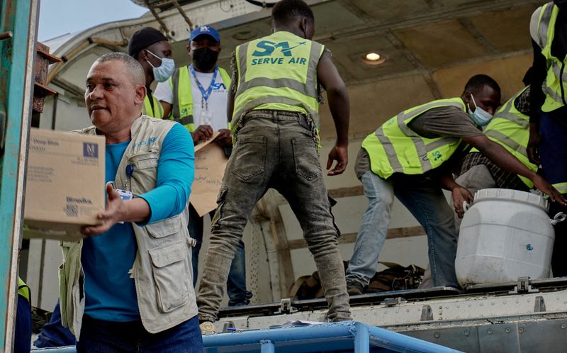 UNICEF staff and airport workers unload medical supplies from an aircraft at Bunia National Airport in Democratic Republic of Congo.