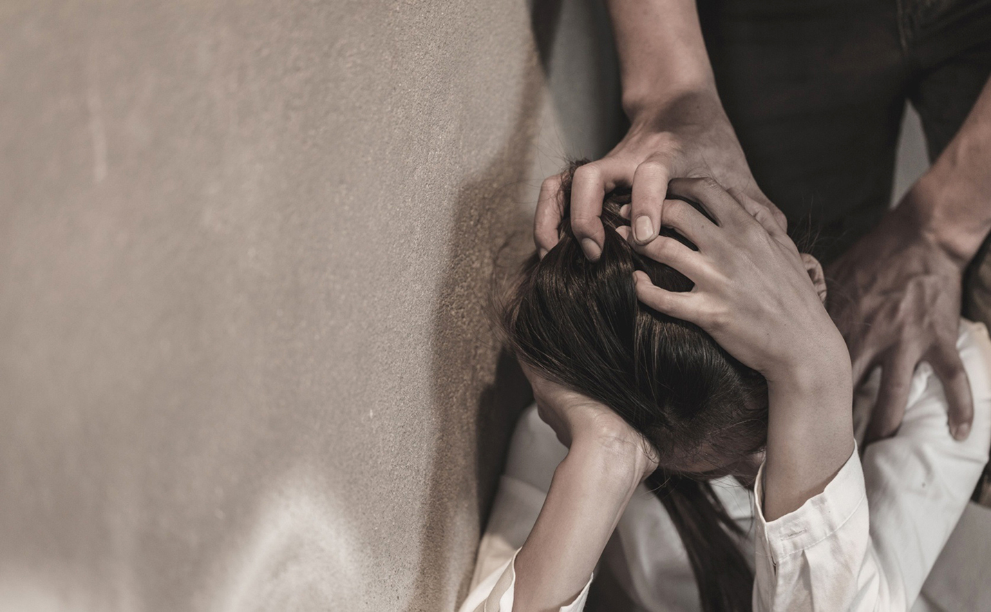 A woman reflecting on domestic abuse and police response failures in South Africa