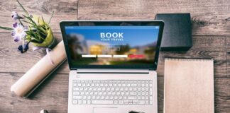 The travel agent isn’t dead yet, but technology means they have to evolve Travel consultant assisting a client with planning a holiday using a laptop